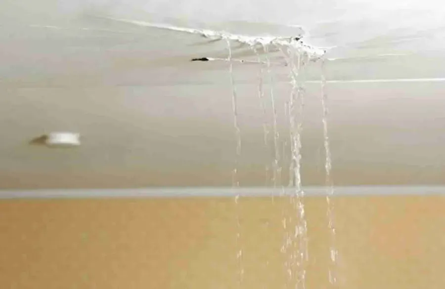 Water streaming through a cracked ceiling in a Duluth home