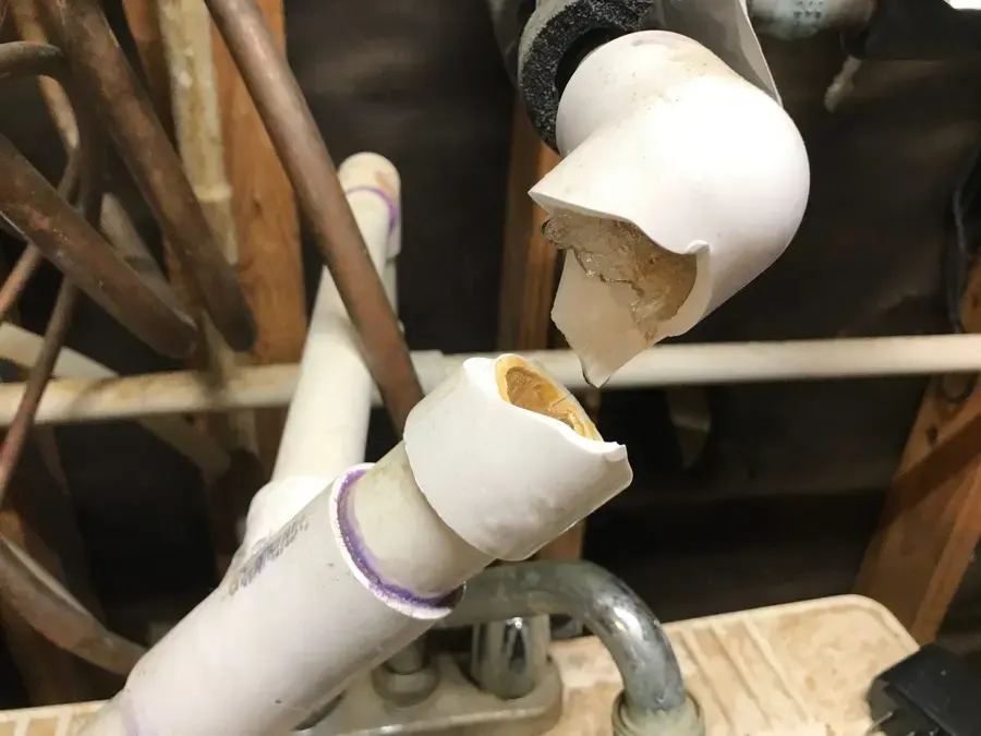 PVC pipe cracked apart by a hard freeze in a Duluth crawl space